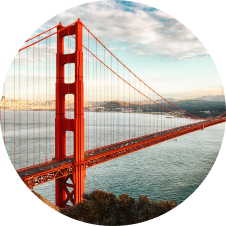 A circular image of the iconic Golden Gate Bridge, showcasing its majestic architecture and vibrant golden hue.